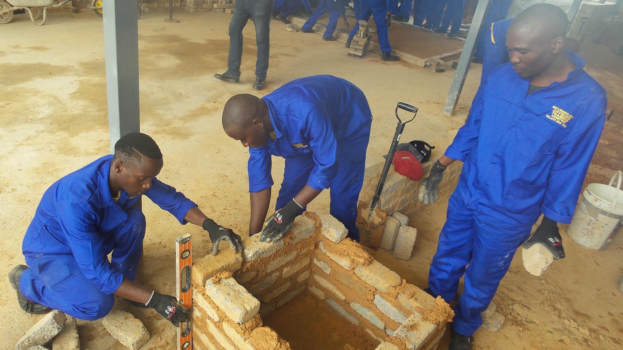 Yakhithika construction team laying bricks on site