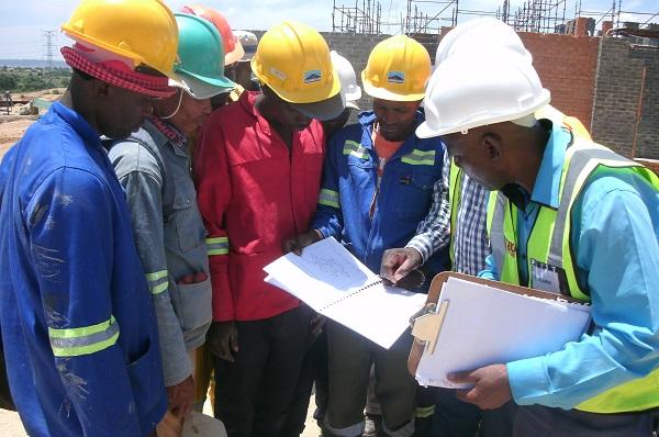 Construction supervisors reviewing plans on site