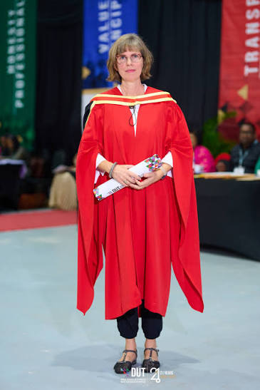Academic portrait in red ceremonial gown