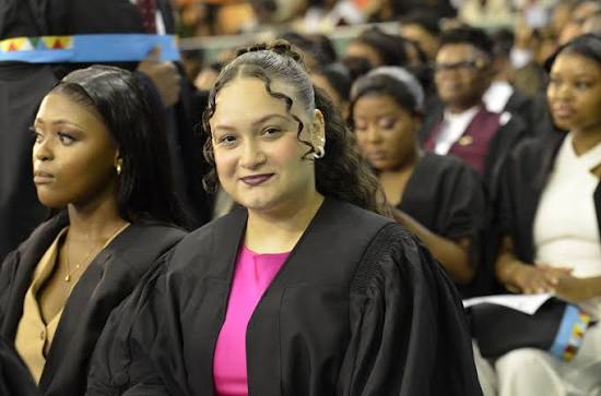 Graduate seated among ceremony audience
